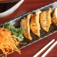 Gyoza (6) · 6 pieces. Pan-fried chicken pot stickers and with dipping sauce.