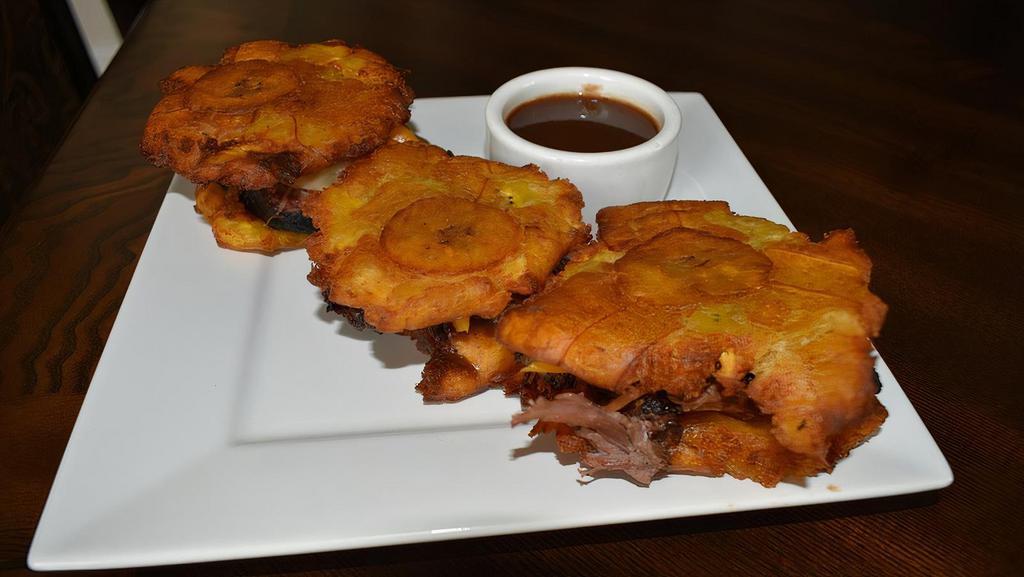 Tostone Sliders · 3 crispy fried pressed Plantains. Served with your choice of smoked meat chicken, brisket, pulled pork, caramelized onions, and bell peppers.