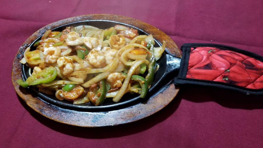 Fajitas Texanas · Tender-sliced beef, chicken and shrimp stir-fried with bell peppers, onions and tomatoes.