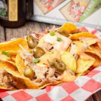 Bbq Nachos · Choice of Brisket or Pulled Pork,  House Made Tortilla Chips Topped with BBQ Queso, Jalapeno...