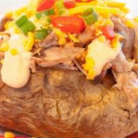 Spud Deluxe · Stuffed potato with Pulled Pork and topped with chipotle sour cream, cheese, green onions an...