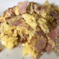 Huevos Con Tocino · Scrambled eggs with bacon.