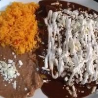 Enchiladas De Mole Con Pollo O Queso · Soft corn tortilla rolls filled with shredded chicken or melted cheese, topped with mole sau...