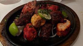 Mixed Grill Platter · A sizzling presentation of assorted clay oven delicacies including tandoori chicken, seekh k...