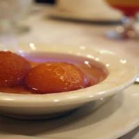Gulab Jamun · Golden fried cheese balls served in honey flavored syrup.