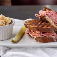Reuben · Corned beef, Swiss cheese, sauerkraut, and Russian dressing, on grilled marble rye.