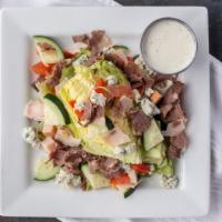 Wedge · Chopped house meats, iceberg wedge, bleu cheese, tomato, cucumber, buttermilk ranch dressing.