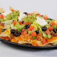 Meat Works Nacho · An appetizer or a meal in itself! Crisp corn chips covered with refritos, enchilada sauce, m...