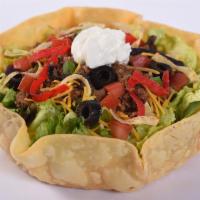 Taco Salad · Lettuce blend, seasoned ground beef, cheddar cheese, black olives, green onions, and tomatoe...