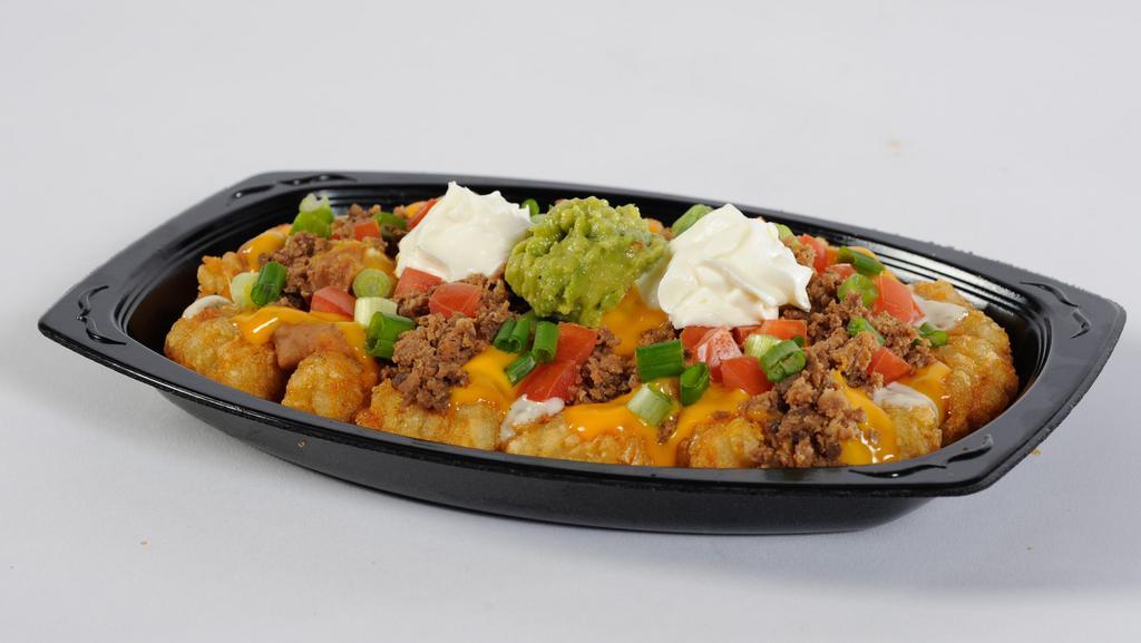 Mexi Fry Nacho · Golden, crisp mexi fries covered with refritos, ranch dressing, cheese sauce, and seasoned ground beef topped with tomatoes, green onion, sour cream, and guacamole.