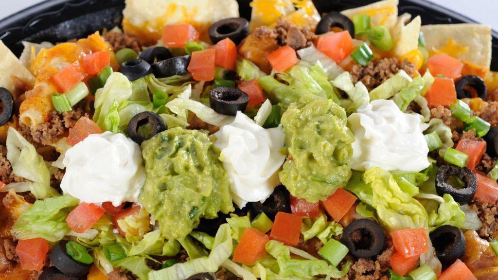 Nacho · An appetizer or a meal in itself! Crisp corn chips covered with refritos, enchilada sauce, melted cheddar, and jack cheese, and topped with guacamole, sour cream, and tomatoes.