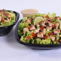 Fiesta Lime Chicken Salad · Seasoned grilled chicken, black beans, red peppers, corn, cheddar cheese, tomatoes, and gree...