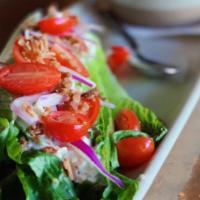 Wedge · A wedge of crisp romaine, bleu cheese dressing, smoked bacon, grape tomatoes, red onion