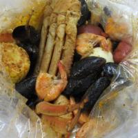 Signature Bombe · 12 lb snow crab legs, 1/2 lb shrimp (no head), 1/2 lb black mussels, 2 boiled egg, 2 corn, a...