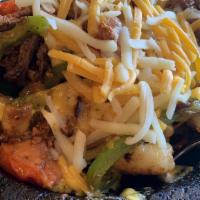 Molcajete Ranchero · Grilled shrimp, sirloin steak, grilled chicken, and Mexican sausage cooked with onion, mushr...
