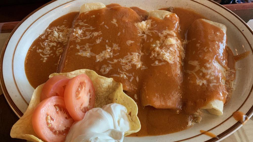 Enchiladas Supreme · Supreme combination of four enchiladas, one chicken, one beef, one cheese, and one bean, covered with ranchero sauce, lettuce, sour cream, tomato.