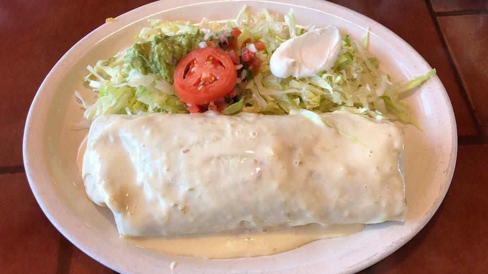 Burrito California · One burrito filled with slow-roasted beef barbacoa, Mexican rice, and refried beans, with cheese sauce on top, served with lettuce, guacamole, sour cream and pico de gallo.