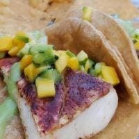 Tropical Fish  · Cajun Seasoned, Mango Cucumber Avocado Cilantro Salsa, Tomatillo Salsa, Corn Tortilla.