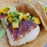 Tropical Fish / Shrimp · Cajun Seasoned, Mango Cucumber Avocado Cilantro Salsa, Tomatillo Salsa, Corn Tortilla.