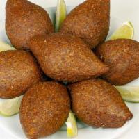 Kibbeh  (Large) · A mixture of bulgur wheat, onions, and ground beef forming  a hollow shell stuffed with grou...