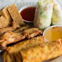 Sampler Platter · A sampling of egg rolls, spring roll, satay, and fried tofu with dipping sauces.