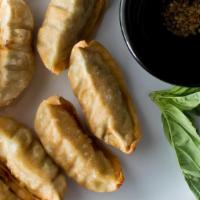 Fried Dumplings · Pork dumplings deep fried and served with garlic-seasoned dark soy sauce.
