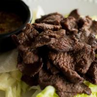 Crying Tiger · Marinated steak cooked, sliced and served on a bed of lettuce with our homemade spicy Talay ...