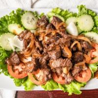 Cambodian Beef Stir Fried (Lok Lak) * ツ · Stir-fried marinated, cubed tenderloin in black pepper, garlic and soy sauce. Served on a be...