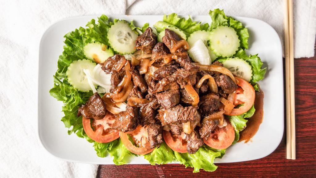 Cambodian Beef Stir Fried (Lok Lak) * ツ · Stir-fried marinated, cubed tenderloin in black pepper, garlic and soy sauce. Served on a bed of fresh mixed vegetables and dipping sauce of lime juice, sea salt and black pepper. Served with steamed jasmine rice(White Rice).