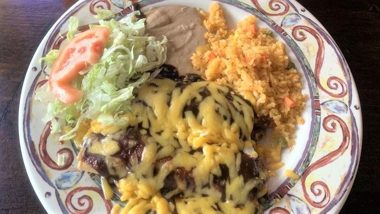Enchiladas Mole Dinner · 3 ENCHILADAS topped with mole sauce & yellow cheese. Served with Spanish rice & refried beans.<br /><br />