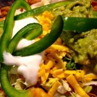 Taco Salad · Crisp flour tortilla shell filled with lettuce, tomatoes, bell pepper, cheese, green onions ...