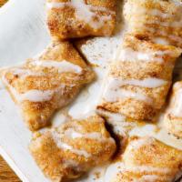 Cinna Bites · Our homemade dough, lightly spread with cream cheese, sprinkled with cinnamon & sugar and ba...