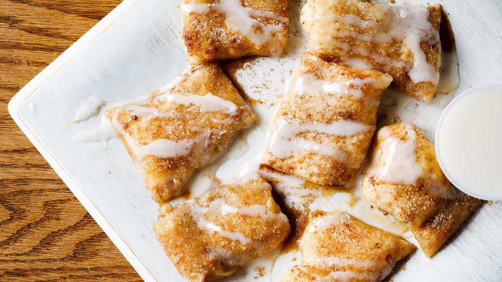 Cinna Bites · Our homemade dough, lightly spread with cream cheese, sprinkled with cinnamon & sugar and baked to perfection; served with Ziggy's homemade icing.