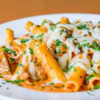 Baked Sausage Paisano · Rigatoni in our signature vodka sauce with home-made Italian sausage & mushrooms covered wit...