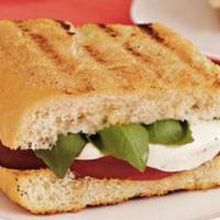 The Caprese · Melted Mozzarella cheese with tomato and basil grilled between two slices of buttered bread.