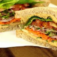 Harvest Veggie Sandwich · Homemade Hummus, Shredded Carrots, Sprouts, Oil and Vinegar, Grilled Onions, Cucumbers, Spin...