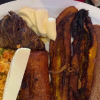Salvadorian Breakfast · Fried plantain, eggs, meat, tamal, frijoles y tortillas. sour cream and queso fresco
