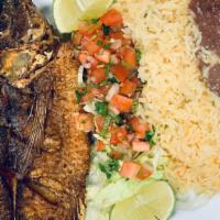 Fried Mojarra · Seerved with rice, beans, and salad.