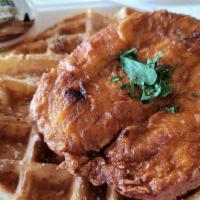 Chicken & Waffles · A fluffy Belgian waffle topped with crispy fried chicken, maple syrup, and powdered sugar.