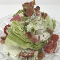 Wedge Salad · Iceberg lettuce, tomato, bacon, pickled red onion, and bleu cheese dressing.