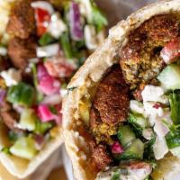 Falafel (Vegan) · Deliciously grilled pita bread stuffed with our homemade, authentic falafel topped with humm...