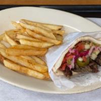 Kafta Kabob · Fire roasted ground lamb and beef served on a grilled pita topped with hummus, cabbage, Jeru...