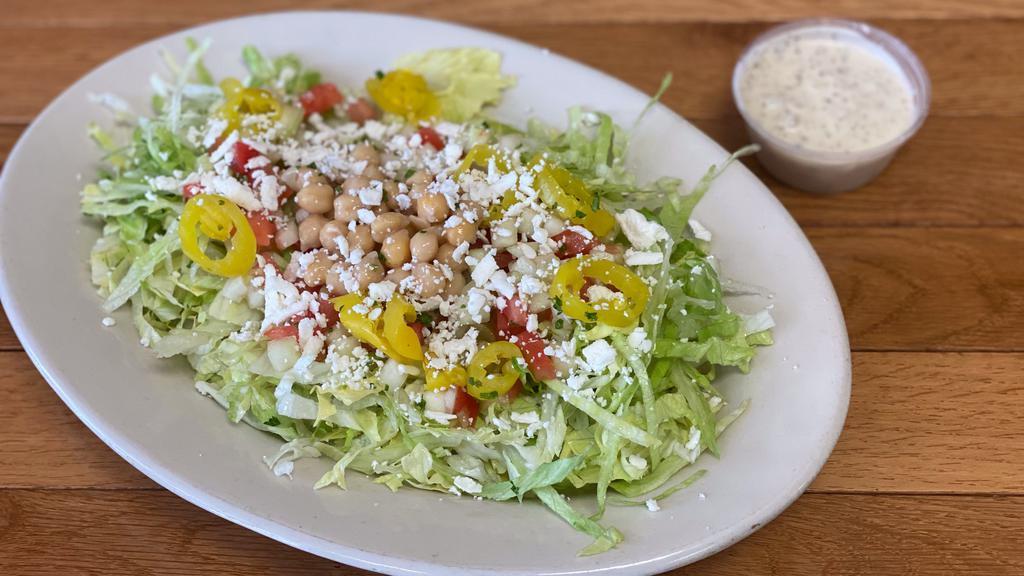 Greek Salad · Classic Greek salad including Jerusalem salad, lettuce, onions, pickles, chick peas, banana peppers, feta cheese with a side of Tzatziki dressing!