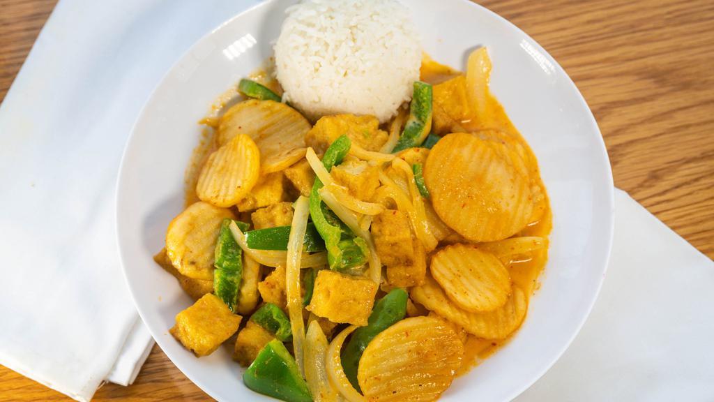 Potato Curry · Gluten-free. Fried potato, onion, bell pepper, red coconut curry sauce. Served with a scoop of rice.