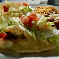 Taco Dinner · Chicken or beef tacos served with rice and beans.