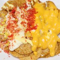 Tostielote · Tostitos topped with sweetcorn, mayonnaise, butter, nacho cheese, cotija cheese, chile powde...