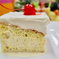 Tres Leches Cake · Soaked in three luscious milks
and covered with a satiny
white cream topping