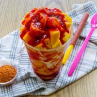 Mangonada · Delicious treat made of mango ice cream , chamoy, tajin and topped with diced pieces of fres...