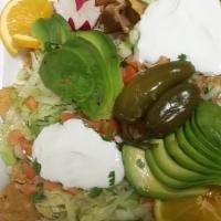 Super Nachos · El Palmar's loaded super nachos prepared with your choice of meat - topped with lettuce, tom...