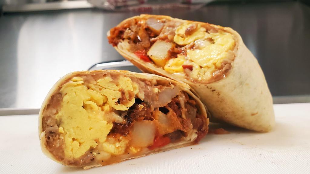 Burrito Mañanero · Breakfast burrito. Refried pinto beans, sauté onions and peppers, potatoes, scrambled eggs, cheese, fresh salsa and your choice of protein on a flour tortilla.